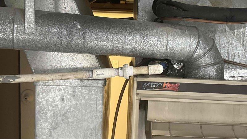 Responded to customer concern regarding water leaking from ductwork in mechanical space. Upon inspection, identified significant condensation accumulation on insulated ductwork surface due to inadequate insulation and temperature differential. Verified WhisperHeat HVAC system operational status and confirmed unit cooling effectively with amperage reading of 14.46 amps at outdoor condensing unit. Inspected ductwork routing through attic/utility space and noted moisture present on flexible duct surfaces. Explained to customer that condensation is forming on cold supply ducts when warm, humid air contacts inadequately insulated duct surfaces. Recommended improving duct insulation and verifying proper vapor barrier installation to prevent future moisture accumulation and potential water damage to surrounding building materials.