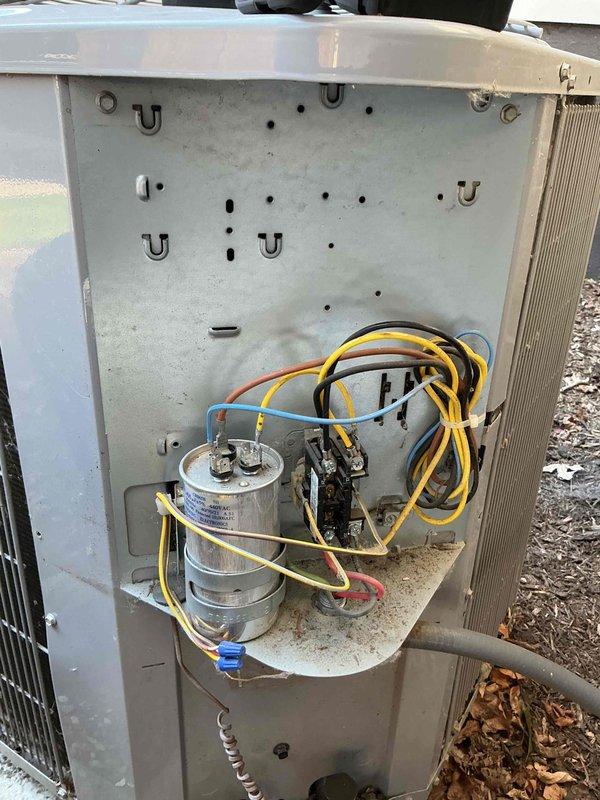 Completed spring maintenance clean and check on a two-system HVAC setup consisting of an outdoor air conditioning unit and an indoor furnace system per the Comfort Plan agreement. Performed comprehensive inspection of the outdoor condensing unit, examining electrical components including the capacitor, contactor, and associated wiring connections. Assessed the condition of the condenser coil and verified proper wire routing through mounting points. Inspected the indoor furnace system, evaluating the blower motor assembly, control board, and all electrical connections throughout the unit. Documented equipment condition through photographic records showing both systems' internal components and overall operational status. All components found operational with normal wear consistent with age and outdoor exposure.