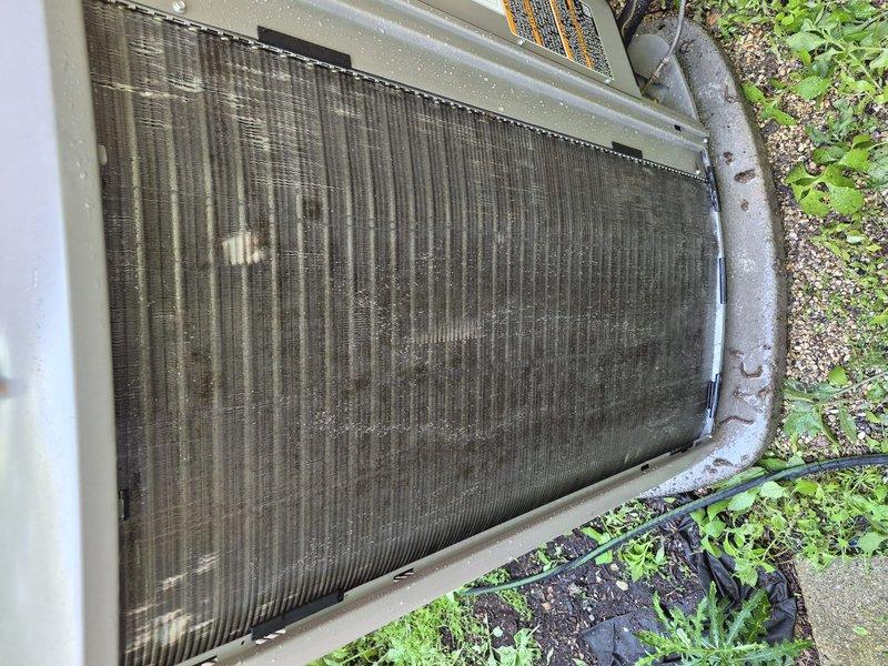 Completed comprehensive air conditioning tune-up and maintenance on single system. Condenser coil showed significant accumulation of dirt, debris, and environmental contaminants requiring thorough cleaning to restore proper airflow and heat transfer efficiency. Inspected all electrical components, verified proper operation of compressor and fan motor, and documented unit condition with photographic records for customer reference.