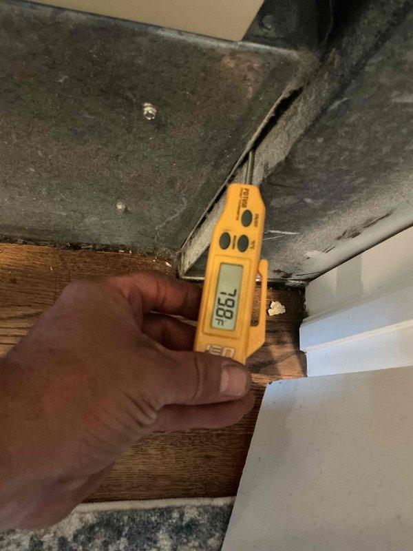 Responded to no cooling complaint on 15+ year old Trane air handler system. Upon arrival, confirmed unit was running but not producing cold air. Performed diagnostic evaluation of the system including temperature differential measurements at supply ductwork, which registered 73.8°F indicating insufficient cooling. Inspected air handler unit located in utility closet and assessed overall system condition. Identified failed cooling component preventing proper refrigeration cycle operation. Discussed repair options and replacement recommendations given age of equipment, as systems over 15 years typically experience declining efficiency and increased failure rates of major components.