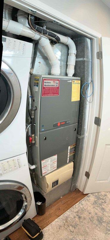 Responded to no cooling complaint on 15+ year old Trane air handler system. Upon arrival, confirmed unit was running but not producing cold air. Performed diagnostic evaluation of the system including temperature differential measurements at supply ductwork, which registered 73.8°F indicating insufficient cooling. Inspected air handler unit located in utility closet and assessed overall system condition. Identified failed cooling component preventing proper refrigeration cycle operation. Discussed repair options and replacement recommendations given age of equipment, as systems over 15 years typically experience declining efficiency and increased failure rates of major components.