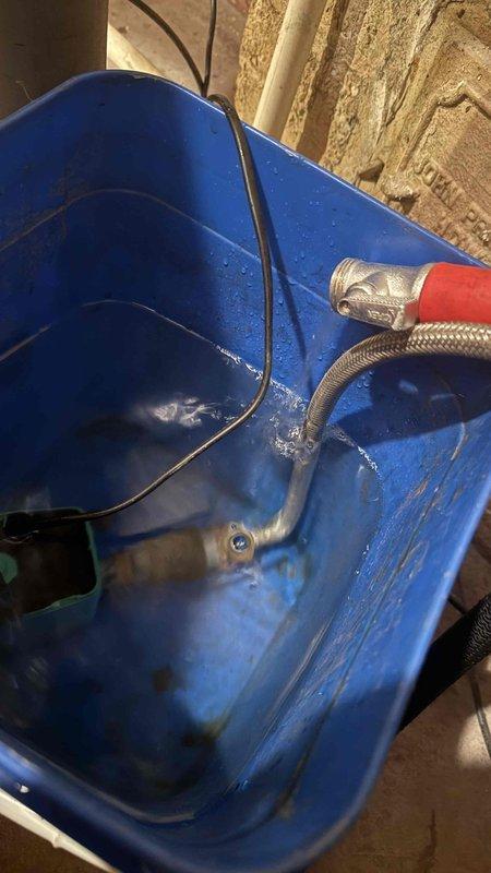 Performed tankless water heater flush service. Isolated unit using service valves, connected submersible pump with braided flex hoses to circulation bucket, and circulated descaling solution through heat exchanger to remove mineral buildup and restore optimal performance.