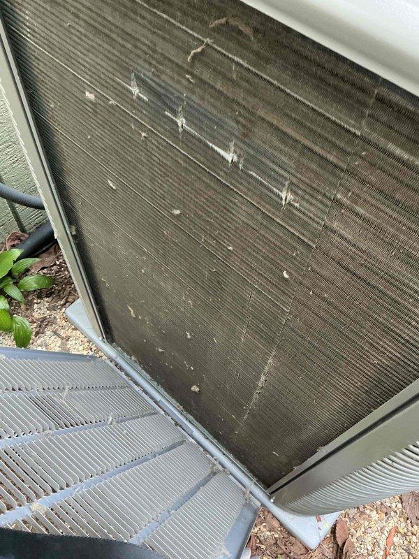 Responded to no cooling complaint and performed diagnostic inspection of outdoor air conditioning unit. Found condenser coil heavily obstructed with dirt, dust, and organic debris accumulation, significantly restricting airflow and reducing system efficiency. Documented equipment information and discussed maintenance recommendations with customer to restore proper system operation.