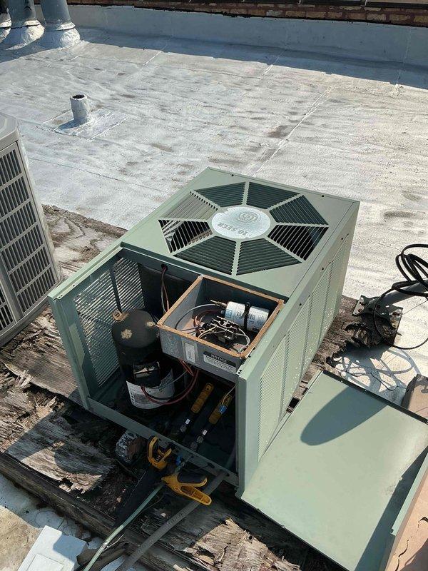 # HVAC Maintenance - Comfort Plan Clean and Check 1 System

Performed comprehensive preventive maintenance on rooftop-mounted air conditioning system per comfort plan agreement. Accessed unit by removing service panels to inspect internal components including compressor, capacitors, refrigerant lines, and electrical connections. Utilized manifold gauges to verify refrigerant pressures and system performance. Measured and recorded temperature readings, documenting 58.4°F at specified test point using digital thermometer to confirm proper cooling operation. All components inspected and found operating within normal parameters. System left in proper working condition with panels secured.