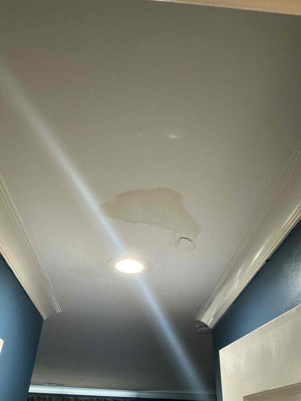 Responded to warranty call for HVAC unit installed in January 2026 reporting active leak causing interior damage. Upon arrival, documented extensive ceiling and wall damage in bedroom area with collapsed drywall, exposed structural joists, and visible water staining on adjacent ceiling surfaces. Photographed all affected areas including compromised ceiling structure, water intrusion patterns, and resulting drywall deterioration to assess leak source and determine if damage is related to recent installation.