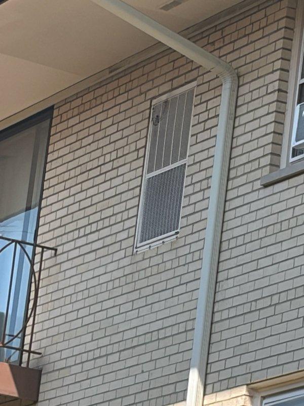 Performed diagnostic evaluation on aging residential air conditioning system approximately 40 years old. Conducted visual inspection of outdoor condenser unit mounted on exterior building wall and assessed interior components. Due to advanced age of equipment, provided comprehensive repair estimate to homeowner for necessary service work.