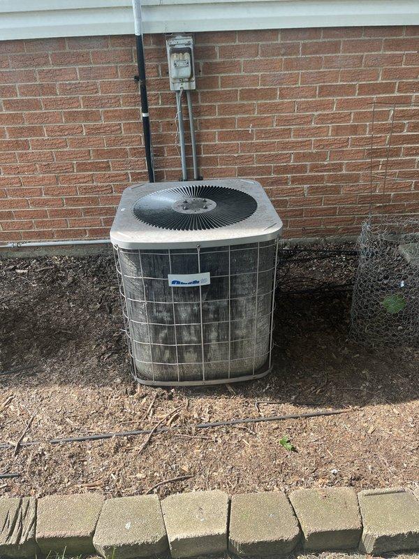 Responded to no cooling complaint and found system had been off due to previous frozen coil condition. Upon arrival, performed diagnostic testing of refrigerant charge and temperature differentials, which revealed all readings within normal parameters. Identified severely restricted air filter as root cause of frozen evaporator coil and loss of cooling capacity. Replaced air filter and performed complete system maintenance including inspection of both indoor and outdoor equipment. During maintenance inspection, discovered failed blower capacitor reading out of specification, condenser capacitor testing out of range, and contactor showing pitting on contact points. Replaced all three failed components to restore proper system operation. Discussed system age and replacement options with homeowner, who elected to proceed with component repairs at this time. Verified proper system operation with all equipment running within manufacturer specifications and delivering adequate cooling upon c