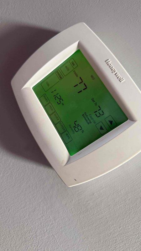 Responded to callback for recurring cooling issue following previous service visit. Upon arrival, verified thermostat displaying 73°F with customer reporting inadequate cooling and indoor temperature of 76°F. Inspected HVAC control board and wiring connections within air handler, checking all low-voltage control wiring, power connections, and relay operations for proper function. Documented system conditions with photos of thermostat operation and control board assembly to verify system status and troubleshoot recurring temperature control concerns.