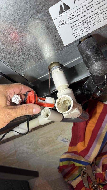 Responded to no cooling complaint where system was short cycling and shutting off multiple times throughout the day. Inspected condensate drain system and found clogged drain line causing float switch to trip and shut down system for safety. Cleared blockage from PVC drain line using appropriate tools and verified proper drainage flow. Tested system operation and confirmed unit running normally with adequate cooling and no further safety shutoffs.
