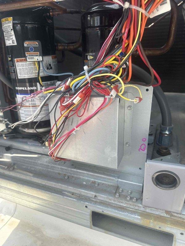 Responded to commercial cooling complaint at preschool facility unable to maintain temperature below 76°F. Performed diagnostic inspection of rooftop unit, examining Copeland compressor assembly, electrical control panel, contactors, and associated wiring connections. Documented system components including capacitor housing, terminal blocks, and control circuitry for assessment. Coordinated with office for approval authorization prior to proceeding with repairs per established protocol for commercial property management accounts.