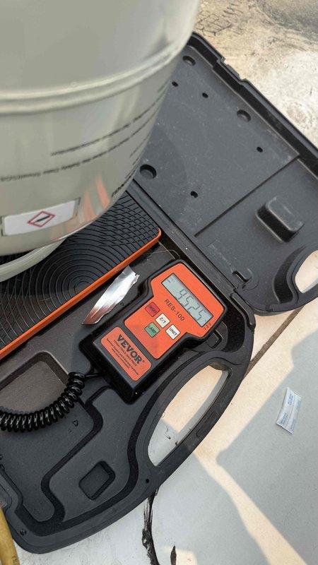 Responded to no-cooling complaint on commercial rooftop HVAC system. Upon arrival, verified thermostat was set to cooling mode at 70 degrees but unit was not reaching setpoint and blowing warm air. Performed visual inspection of rooftop condensing units and confirmed unit operation status. Utilized refrigerant scale and diagnostic equipment to assess system charge levels and operational parameters. Checked electrical connections, disconnect boxes, and verified proper power supply to affected unit. Inspected refrigerant lines, conduit routing, and all accessible components for visible defects or abnormalities. Documented equipment conditions with photographic evidence showing unit configuration and diagnostic tool readings for service records.