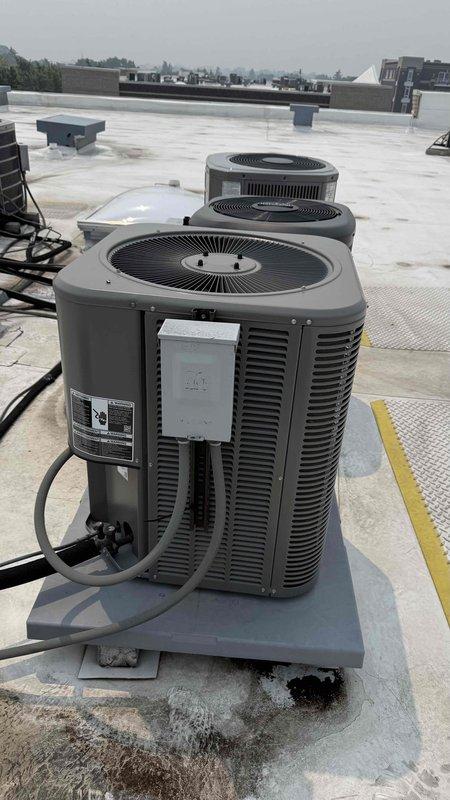 Responded to no-cooling complaint on commercial rooftop HVAC system. Upon arrival, verified thermostat was set to cooling mode at 70 degrees but unit was not reaching setpoint and blowing warm air. Performed visual inspection of rooftop condensing units and confirmed unit operation status. Utilized refrigerant scale and diagnostic equipment to assess system charge levels and operational parameters. Checked electrical connections, disconnect boxes, and verified proper power supply to affected unit. Inspected refrigerant lines, conduit routing, and all accessible components for visible defects or abnormalities. Documented equipment conditions with photographic evidence showing unit configuration and diagnostic tool readings for service records.