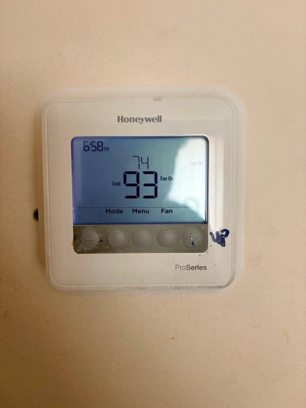 Responded to no cooling complaint. Upon arrival, found thermostat displaying 74°F actual temperature while set to 93°F in cooling mode with system calling for cooling and fan operation. Inspected electrical panel and verified power supply to HVAC equipment. Documented thermostat settings and electrical distribution panel condition for service records.