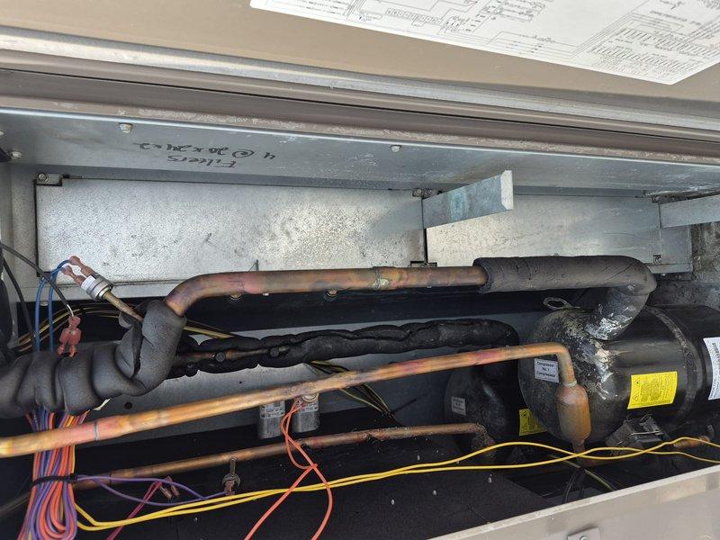 Completed scheduled commercial HVAC maintenance agreement service on rooftop unit, replacing four 20x24x2 filters as part of summer filter change protocol. Performed annual coil cleaning by blowing evaporator coil with nitrogen to remove debris and maintain optimal heat transfer efficiency. Documented existing copper refrigerant line condition showing oxidation and patina, along with aging insulation on suction line requiring future monitoring.