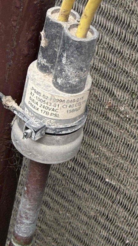 Responded to no cooling call on residential air conditioning system. Upon arrival, performed system diagnostics and inspected outdoor unit components. Found capacitor showing signs of wear and dust accumulation, with visible electrical connections requiring attention. Inspected refrigerant lines and electrical wiring connections at outdoor unit, noting moisture presence on suction line indicating system had been attempting to operate. Evaluated capacitor specifications and electrical connections to compressor circuit. Documented component conditions through photography for service records. System required capacitor replacement and electrical connection service to restore cooling operation.