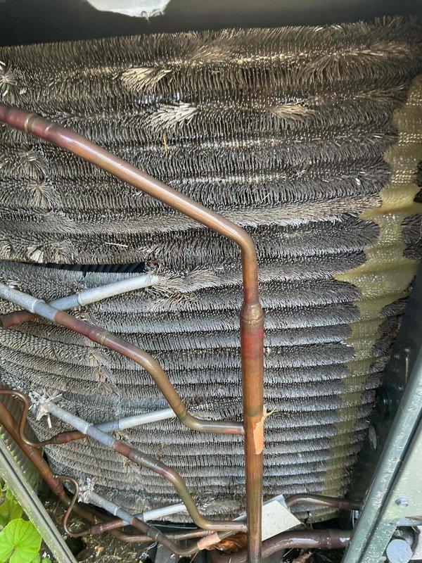 Responded to no-cool call on 4-year-old central air conditioning system. Upon arrival, confirmed unit would not power on and thermostat displayed permanent hold setting at 70°F with ambient temperature reading of 76°F. Inspected outdoor condensing unit and indoor evaporator coil assembly. Found evaporator coil showing normal operational wear with some minor debris accumulation between fins and typical copper refrigerant line oxidation consistent with unit age. Verified thermostat functionality and system wiring connections. Troubleshot electrical components and restored system operation, confirming proper startup sequence and cooling cycle initiation.