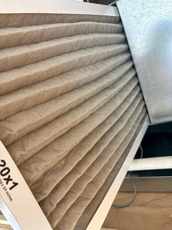Responded to no cooling complaint on 6-9 year old system with air handler located in attic above shower area. Upon inspection, found Mosquito drain safety float switch tripped and in alarm state, indicating primary condensate drain line blockage. Observed moderately soiled 20x1 air filter requiring replacement. Cleared condensate drain obstruction, reset safety switch, and replaced air filter. System restored to normal cooling operation with proper condensate drainage confirmed.