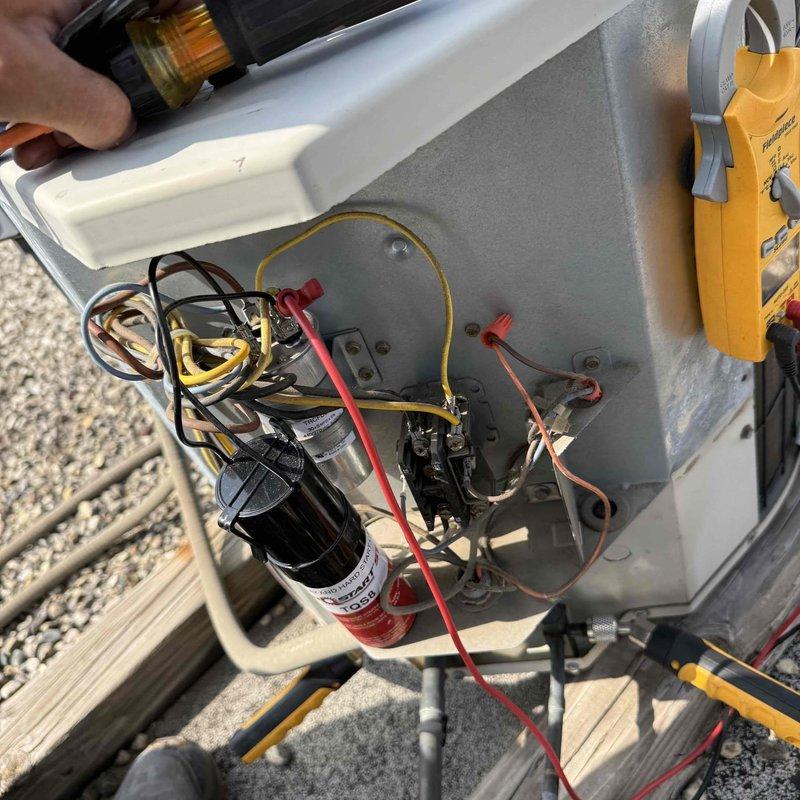 Responded to callback for air conditioning unit producing loud rattling noises described as "bowling balls" inside the system. Accessed electrical compartment and inspected capacitors, wiring connections, and internal components while performing diagnostic testing with field meter. Measured supply air temperature at 79°F and evaluated system operation. Addressed customer concerns following previous service visit and completed thorough inspection of outdoor unit to identify source of mechanical noise and ensure proper system function.