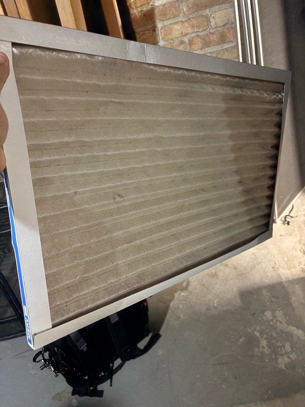 Responded to no cooling call for 4-year-old residential AC system. Upon arrival, discovered heavily soiled air filter with significant dust and debris accumulation restricting airflow. Replaced dirty filter with new unit to restore proper system operation. Observed moisture staining on basement floor near electrical components and noted corrosion on switch housing, which may require future attention. Advised customer that lack of regular maintenance since 2023 could potentially void manufacturer warranty on 2022 installation. System restored to normal cooling operation with improved airflow throughout residence.