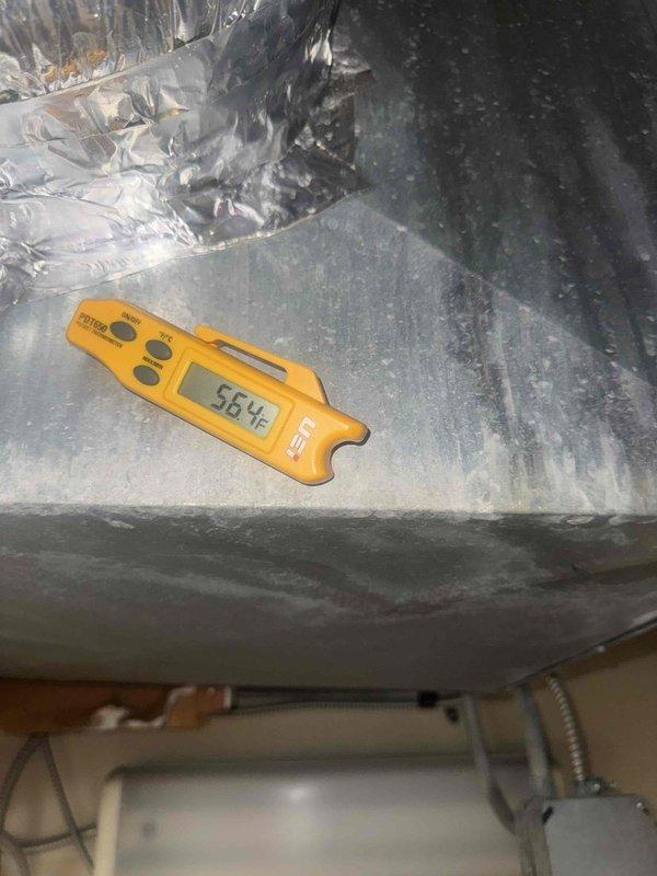 Responded to no cooling call at commercial facility. Upon arrival, found outdoor condenser unit operational but system not providing adequate cooling. Measured supply air temperature at 56.4°F, indicating insufficient cooling capacity. Inspected condenser unit exterior, noting debris accumulation around base and coil surfaces requiring cleaning. Assessed refrigerant charge and system performance. Collected payment for service call and diagnostic work, with additional repairs and labor to be billed separately.