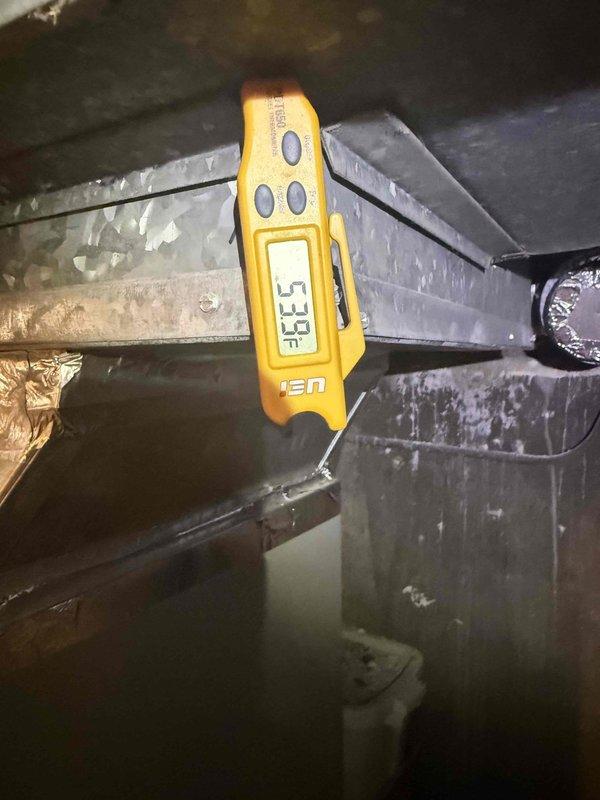 Responded to low cooling complaint and performed system diagnostics. Found refrigerant charge low on R-410A system. Located and sealed refrigerant leak, then added 1 pound of R-410A refrigerant to restore proper system charge. Verified supply air temperature of 57.9°F and return air temperature of 23.8°F, confirming adequate system performance and temperature split. System operating within normal parameters upon completion. Documentation photos captured for service records.