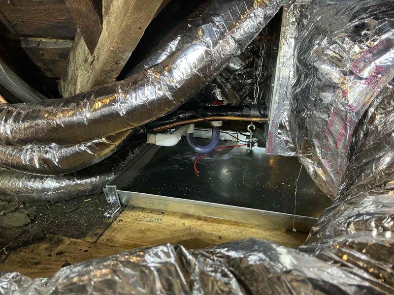 Completed no-charge return trip to address installation punch list items on attic-mounted air handler system. Installed wet switch in overflow pan and relocated hallway supply register by cutting new attic floor opening, ensuring structural integrity of joists and blocking remained intact, then secured pan to plywood flooring using folded cleats. Reconfigured ductwork by disconnecting two temporary bedroom supply runs and two future-use trunk connections, reconnecting proper bedroom circuits with additional 12' of supply tubing added to both bedroom runs and hallway run, with excess tubing coiled neatly behind equipment. Installed and wired A2L refrigerant coil sensor and control system. Corrected drain line pitch after trap to ensure proper condensate drainage. All duct alterations, connections, and penetrations were properly insulated and sealed with foil tape per code requirements, utilizing 36' of Unico supply tube, three supply couplings, and appropriate sealing materials.