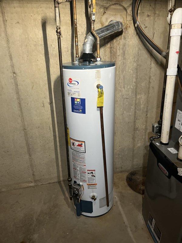 Responded to service call for non-operational water heater in basement utility area. Upon inspection, confirmed existing unit was a power vent model requiring replacement. Assessed installation site, documenting current configuration including metallic exhaust vent pipe, copper supply lines, yellow-handled ball valve, and associated plumbing connections. Evaluated utility room setup with concrete block walls, existing piping infrastructure, and adjacent water treatment equipment. Prepared comprehensive estimate for power vent water heater replacement including removal of existing unit, installation of new comparable power vent model, connection of hot and cold water supply lines, proper venting configuration, and all necessary fittings and materials to complete installation per code requirements.