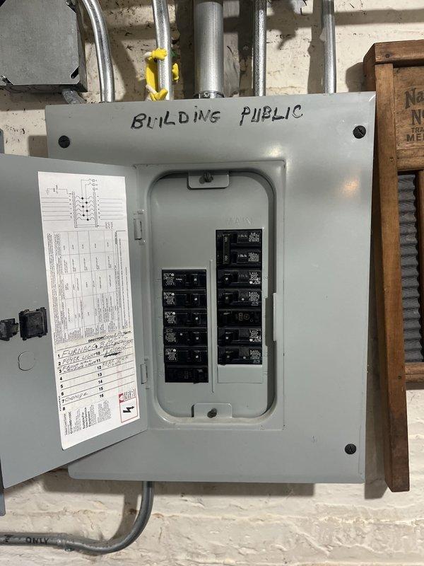 Conducted site assessment for mini-split installation at two-flat residential property currently utilizing window AC units. Evaluated existing electrical panel and determined additional breaker capacity will be required to support new mini-split system. Assessed exterior alleyway access between buildings for outdoor condenser unit placement and reviewed conduit routing options for refrigerant lines and electrical connections.