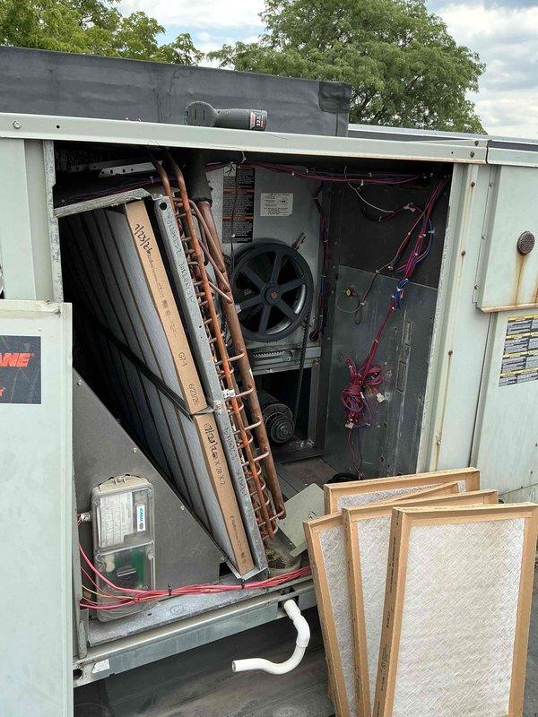 Completed summer preventive maintenance filter change on commercial HVAC system per agreement specifications. Replaced filters on RTU#1 with two 20x20x2 filters and four 20x25x2 filters, inspected BX70 belt. Replaced six 16x20x2 filters on RTU#2 and inspected BX42 belt. Changed one 20x25x1 filter on air handler located in basement storage room/south hallway. All units inspected, access panels secured, and systems left in proper operating condition.