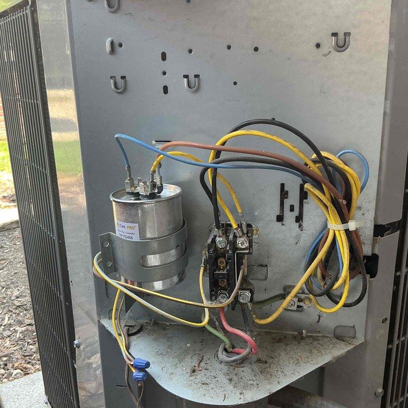 Diagnosed failed capacitor on outdoor air conditioning condenser unit. Replaced defective capacitor with new TITAN PRO THCFD-155 unit rated for proper voltage and microfarad specifications. Verified all electrical connections secure, tested system operation, and confirmed unit returned to normal cooling function.