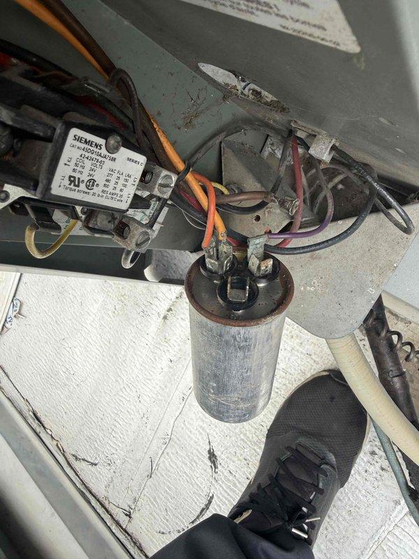 Responded to service call for 18-year-old HVAC system with failed capacitor. Upon inspection, found original JARD capacitor exhibiting significant corrosion and rust on terminal connections, indicating end of service life. Disconnected power to condensing unit, removed deteriorated capacitor, and installed new TITAN PRO TRCFD455 replacement capacitor with proper electrical specifications. Verified all wire connections were secure to capacitor terminals and contactor. Restored power, tested system operation, and confirmed proper startup and cooling cycle functionality.