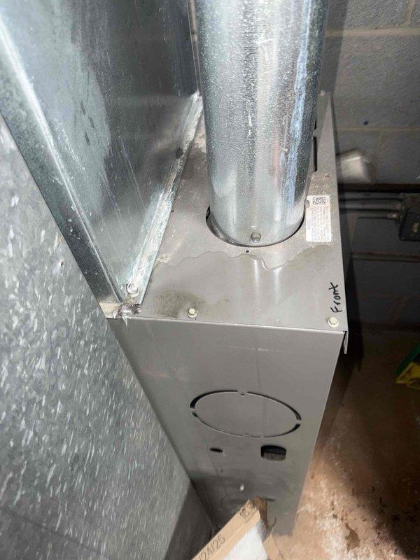 Responded to service call for reported water leak from condensate pump attached to furnace. Upon arrival, performed visual inspection of HVAC system and associated components in basement utility area. Examined furnace installation, ductwork connections, and plenum assembly mounted against foundation wall. Inspected condensate pump and drainage system for signs of active leakage, loose connections, or component failure. Documented existing equipment configuration and condition with photographs showing metal ductwork, plenum box, and HVAC system installation. Collected standard dispatch fee and explained diagnostic process to customer. Discussed available repair options and provided recommendations for addressing the water leak issue. Reviewed new customer discount eligibility and presented information regarding preventative maintenance comfort plan enrollment. Recorded all equipment model numbers and specifications for service records.