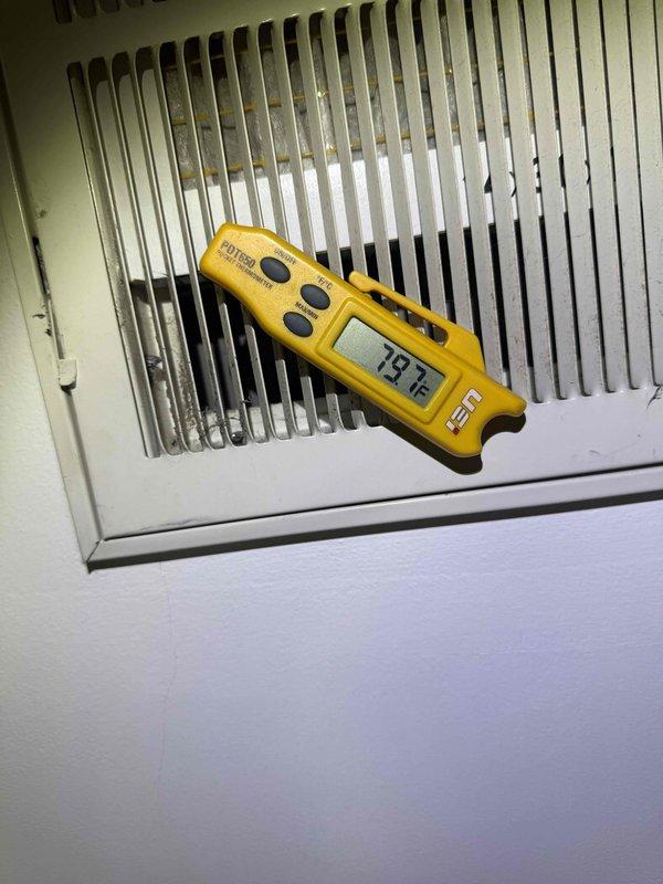 Responded to no-cooling complaint on 15-month-old air conditioning system. Upon arrival, performed system diagnostics and temperature differential measurements at supply and return registers. Supply air temperature measured 79°F at grille, while suction line temperature at outdoor unit measured 56.6°F, indicating inadequate cooling performance and possible refrigerant charge issue or airflow restriction. Conducted thorough inspection of indoor and outdoor components, verified proper thermostat operation, and documented temperature readings with photographic evidence for warranty consideration given system age.