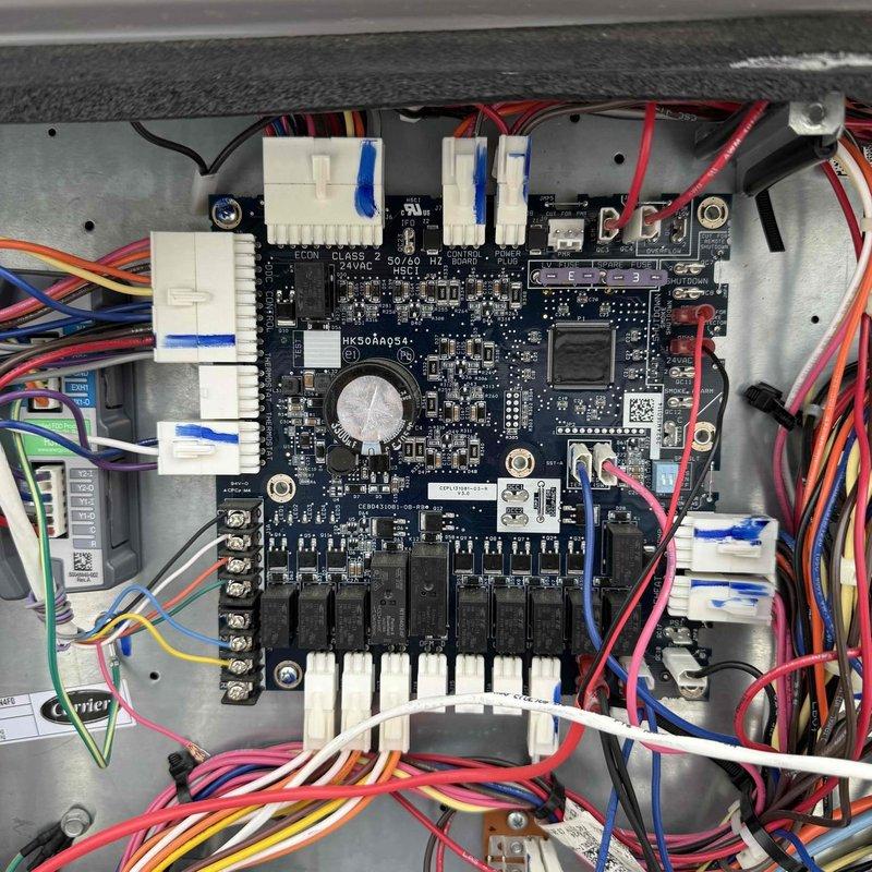 Replaced failed control circuit board on RTU-1 serving Pre-K1/Preschool1 zone in multi-zone HVAC system. Carefully removed and installed new HK50AR054 Class 2 control board with integrated relays, ensuring all wire harness connections were properly seated and system restored to normal operation.