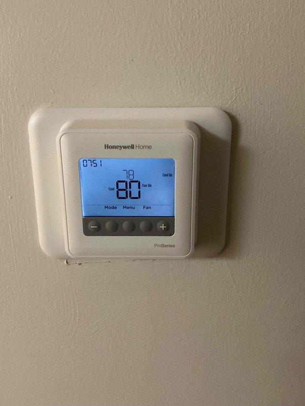 Responded to no cooling complaint on recently installed air conditioning system. Upon arrival, performed diagnostic evaluation of thermostat operation and system performance. Verified thermostat settings on Honeywell ProSeries programmable unit, confirming proper configuration for cooling mode. Measured supply air temperature at air handler using differential thermometer, recording 79.5°F reading. System found to be operating but not achieving adequate cooling performance, indicating potential refrigerant charge issue or airflow restriction requiring further diagnosis and repair.