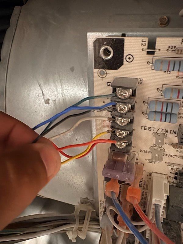 Responded to no cooling complaint on 9-year-old first floor unit. Found thermostat calling for cooling with setpoint at 69°F and current temperature at 75°F, but system not producing cold air. Inspected control board wiring and terminal connections at air handler, verified proper wire placement and secure connections to control board terminals and contactor relay.
