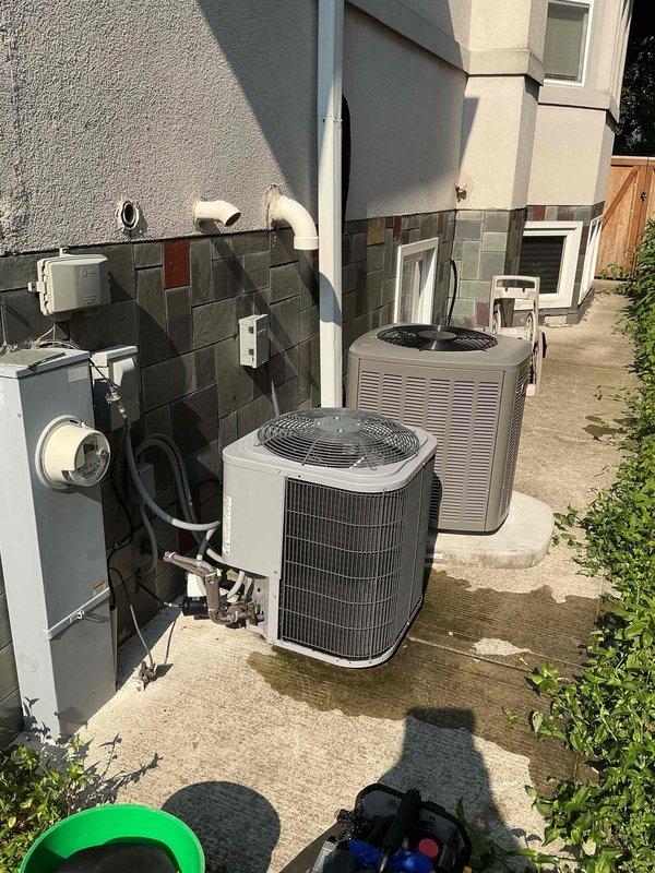 Returned to address recurring leak from attic pipe on recently serviced HVAC unit. Previous day's service was interrupted due to power outage, preventing completion of work. Inspected dual condensing unit installation on exterior pad and indoor mechanical room containing furnace and water heater with associated ductwork and piping systems. Completed repair work on leaking attic pipe and verified all connections for proper operation.