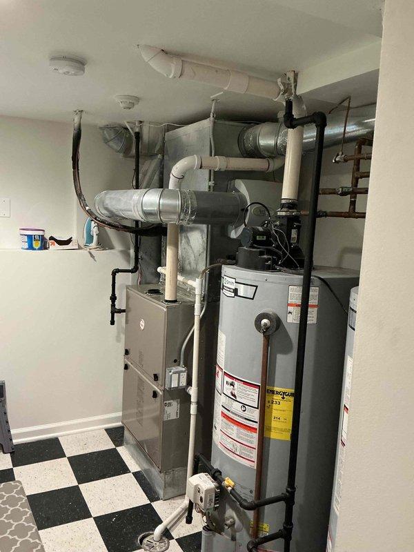 Returned to address recurring leak from attic pipe on recently serviced HVAC unit. Previous day's service was interrupted due to power outage, preventing completion of work. Inspected dual condensing unit installation on exterior pad and indoor mechanical room containing furnace and water heater with associated ductwork and piping systems. Completed repair work on leaking attic pipe and verified all connections for proper operation.