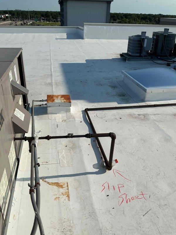 Conducted comprehensive rooftop inspection of multiple condensing units to assess electrical and mounting deficiencies. Documented deteriorated 30-year-old flexible electrical conduit whips and disconnect boxes that sustained wear during recent roof replacement project, requiring full replacement for all rooftop units. Identified numerous condensing units with inadequate support and improper mounting conditions resulting from equipment replacements over time. Photographed existing conditions including York-branded unit installations, corroded piping components, and missing equipment mounting pads. Recommended installation of plastic equipment pads where absent and correction of all mounting deficiencies to ensure proper equipment support and code compliance, with work scheduled for completion after cooling season.