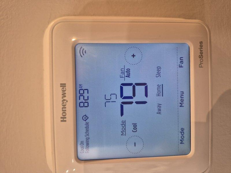 Completed Comfort Plan clean and check maintenance on single HVAC system. Inspected and verified proper operation of Honeywell ProSeries programmable thermostat displaying 72° in cooling mode with WiFi connectivity functional. Confirmed 20x25x1 Filterbuy pleated air filter properly installed in return air system with clean condition noted. Collected annual plan renewal payment and documented system condition with photos per maintenance agreement requirements.