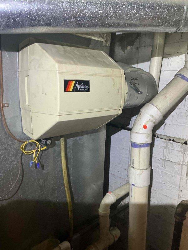 Responded to new customer service call for humidifier operation and functionality assessment. Upon arrival, located Aprilaire humidifier unit installed in basement mechanical room adjacent to air handler system. Observed significant condensation accumulation on ductwork above humidifier, indicating potential over-humidification or control issues. Inspected humidifier control humidistat mounted near unit and assessed operational status. Provided customer education on proper humidistat operation, including seasonal adjustment settings and humidity level recommendations for optimal indoor air quality and equipment performance. Documented existing equipment with photographs showing humidifier installation, ductwork configuration, and mechanical room layout. Discussed repair versus replacement options for humidifier system based on current condition and performance concerns. Noted condensation issues require monitoring and potential humidistat recalibration or replacement to prevent moistur