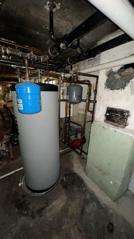 Conducted site assessment of existing NTI boiler system to provide estimate for adding new heating zone and radiator installation. Documented current mechanical room configuration including wall-mounted boiler unit, cylindrical storage tank, expansion tank, and associated copper piping infrastructure. Evaluated existing heating distribution system and available connection points for proposed zone addition, noting all equipment previously installed by our company remains in operational condition.