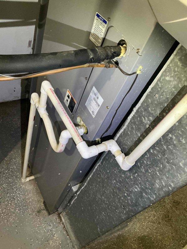 Responded to service call for multiple HVAC concerns including improper air conditioning drainage, heating unit cycling issues with temperature maintenance problems, and basement ductwork leakage. Upon arrival, performed comprehensive system inspection of air handler unit and furnace components. Examined condensate drain lines, PVC drainage system, and refrigerant lines for proper operation and potential blockages. Inspected gas valve assembly, electrical connections, and control modules for proper function. Evaluated blower motor assembly and internal mechanical components. Assessed ductwork connections in basement area for air leakage. Documented equipment specifications and current system condition through photographic evidence. Completed diagnostic evaluation of heating and cooling system to identify root causes of reported performance issues and prepared recommendations for necessary repairs.