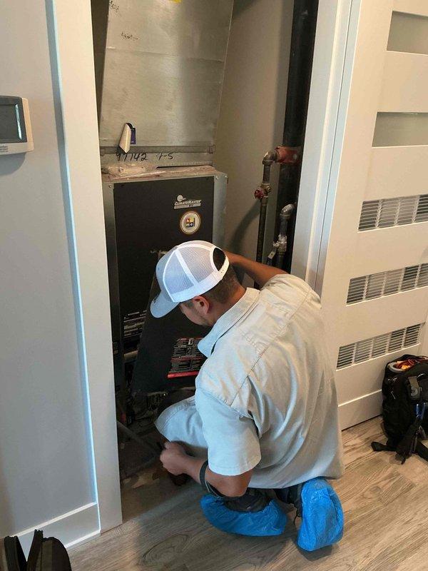 Responded to warranty callback for recurring water leak issue with HVAC unit dripping through wall. Inspected air handler installation in utility closet, examined ductwork connections, and verified proper operation of condensate drainage system. Documented equipment condition including installed Polaris air purifier and filtration components to ensure leak source was identified and system operating within manufacturer specifications.
