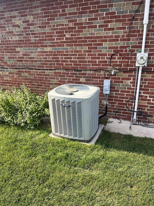 Responded to service call for non-functioning air conditioning system affecting entire residence. Upon arrival, assessed existing 20-year-old outdoor condensing unit and air handler that had previously required dual capacitor replacement. Given the age of the equipment and recurring failures, provided comprehensive estimate for complete HVAC system replacement including new outdoor condensing unit, indoor air handler, refrigerant line set, electrical disconnect, condensate drainage, and all associated components. Documented existing installation configuration with brick wall mounting, concrete pad placement, and current refrigerant piping layout to facilitate accurate replacement planning and equipment sizing recommendations.