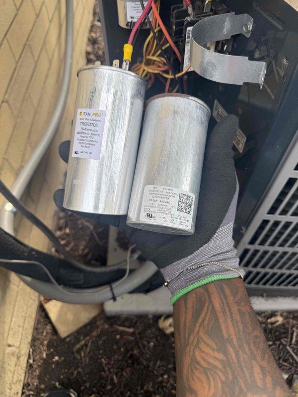 Responded to service call for non-operational 10-year-old air conditioning system with malfunctioning thermostat displaying incorrect heat mode and temperature readings up to 86°F. Upon inspection of outdoor condensing unit, discovered failed dual-run capacitor exhibiting severe corrosion, heat damage, and deterioration on terminal connections. Removed defective capacitor and installed new TITAN PRO replacement capacitor, restoring proper electrical function to compressor and condenser fan motor. Completed clean and check maintenance procedures on both air conditioning condenser unit and air handler as required. System tested successfully with proper cooling operation restored and thermostat communication functioning correctly.