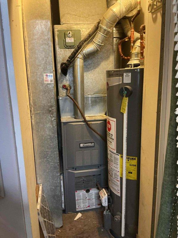 Responded to no cooling complaint on Kenmore HVAC system in condo unit. Upon arrival, found system heating properly but failing to produce cool air. Performed diagnostic evaluation of both indoor furnace unit and outdoor condenser. Inspected condenser unit and found significant dirt and debris accumulation on fan housing and grilles, along with visible weathering indicating extended outdoor exposure and lack of regular maintenance. Examined electrical connections and wiring at condenser, noting equipment condition consistent with reported history of minimal prior use by previous owner. Documented equipment information and photographed indoor furnace installation in utility closet along with outdoor condenser condition. Provided homeowner with diagnostic findings and repair options to restore cooling functionality to system.