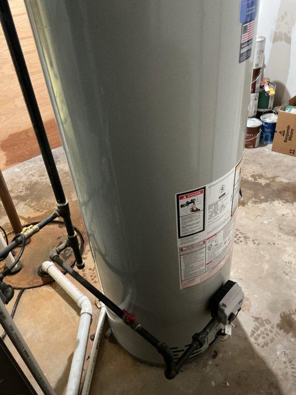 Replaced 50-gallon residential tank water heater in basement utility area. Removed existing unit and installed new water heater with proper venting and code-compliant connections. Connected hot and cold water supply lines using copper piping with brass fittings and shutoff valves. Installed temperature and pressure relief valve with appropriate discharge piping. Verified all connections for leaks, tested unit operation, and confirmed proper heating function. Secured payment information and received lockup instructions as customer needed to leave before completion. All work performed to manufacturer specifications and local plumbing codes.
