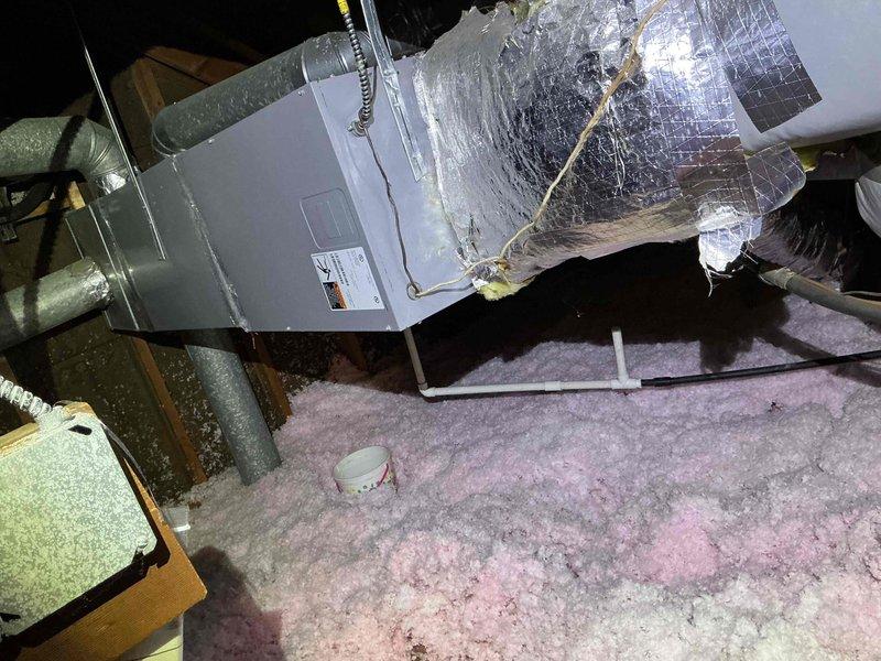 Performed comprehensive tune-up and diagnostic service on dual-system HVAC installation for recently purchased residence. Accessed air handler unit located in attic crawl space, replaced air filters, and completed full system inspection including ductwork and insulation integrity. Diagnosed non-operational outdoor condensing unit and verified primary system maintaining adequate cooling capacity for entire home, with supply air temperature reading 99.1°F documented at main trunk line.
