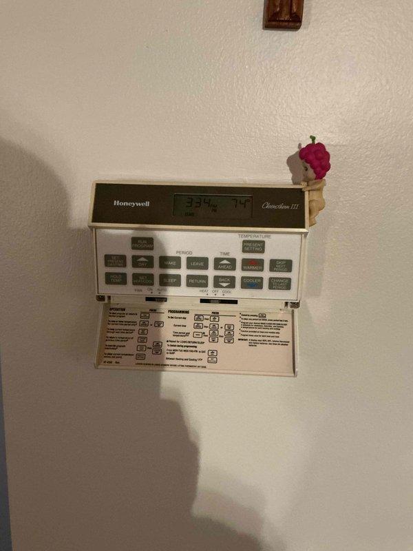 Responded to service call for non-operational air conditioning system on 30-year-old unit. Upon arrival, coordinated access with on-site tenant and performed diagnostic assessment of HVAC system. Inspected Honeywell Chronotherm III programmable thermostat, verifying display functionality and temperature settings. Evaluated indoor furnace unit, examining blower assembly, gas valve controls, wiring connections, and heat exchanger components. Documented system conditions with photographic evidence showing thermostat interface and internal furnace cabinet components including electrical connections, control modules, and mechanical assemblies for service records.